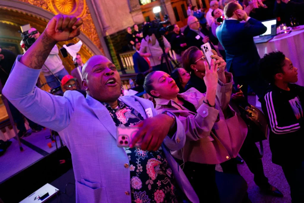 Justin Idleburg, chief executive officer at Cabanne District Community Development Corporation, cheers as Cara Spencer wins St